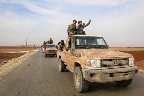 Fighters from the Free Syrian Army celebrate victory after capturing villages that were under the