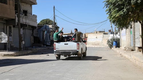 Fighters from the Free Syrian Army celebrate victory after capturing villages that were under the