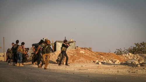 Syrian opposition fighters firing small arms and heavy weapons during the expulsion of ISIS