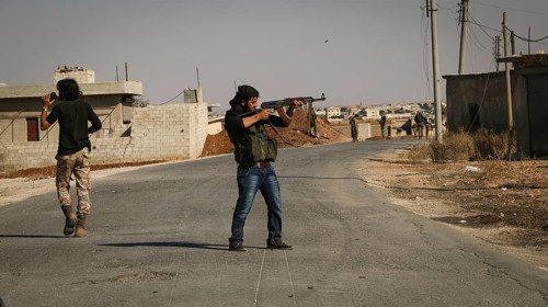 Syrian opposition fighters firing small arms and heavy weapons during the expulsion of ISIS