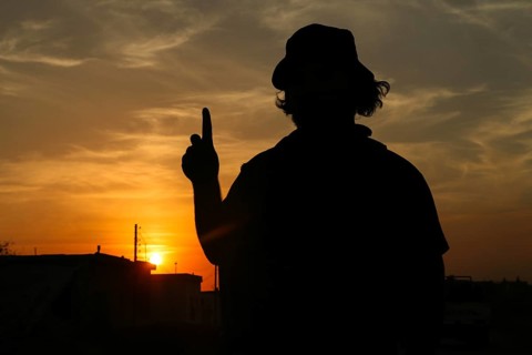 Silhouette of a Syrian armed opposition fighter at sunset, during the war against the PKK. Aleppo,