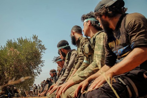 Free Syrian Army fighters praying on the battlefield during combat against terrorist organizations