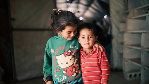 A Syrian refugee child photographed in a camp, reflecting the harsh living conditions of displaced