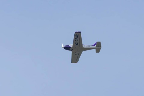 Alpi Pioneer 300 light aircraft flying in a blue sky, England, United Kingdom