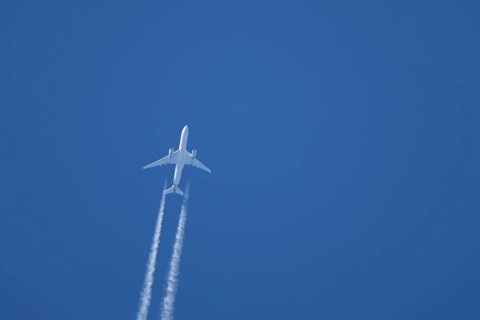 Airbus A350-900 passenger jet aircraft of Singapore airlines flying with a vapour trial or contrail