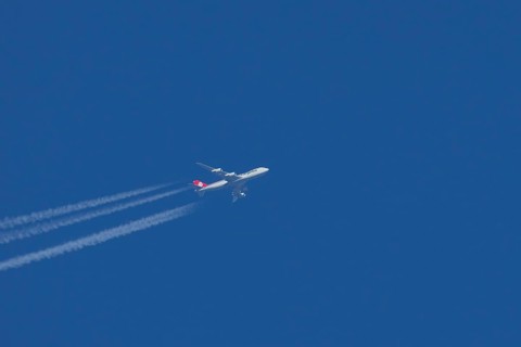Boeing 747 jumbo jet cargo aircraft of Cargolux airlines with a vapour trail or contrail flying in