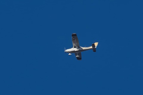 TL Ultralight Sirius 600 light aircraft flying in a blue sky, England, United Kingdom