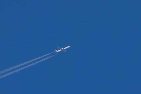 Airbus jet passenger aircraft of Emirates airlines flying with vapour trails or contrails behind in