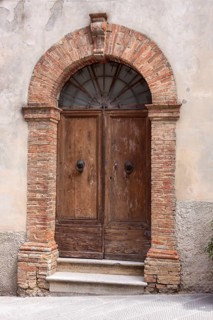 Old wooden entrance door, Montalcino, Province of Siena, Tuscany, Italy