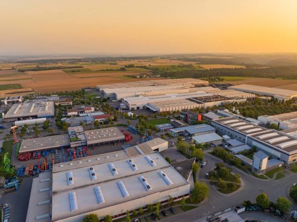 Close-up of an industrial area with buildings and fields in an urban environment at sunset,