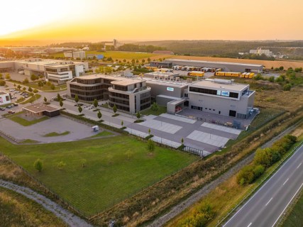 Commercial area with modern buildings and streets in a rural setting in the evening, industrial