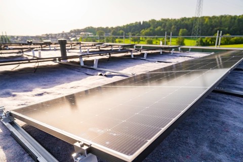 Wide view of solar modules being installed on a roof, PV assembly, commercial customers, new build,