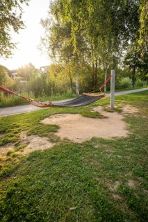 A hammock between trees in a green park at sunset, Nagold, district of Calw, Black Forest, Germany