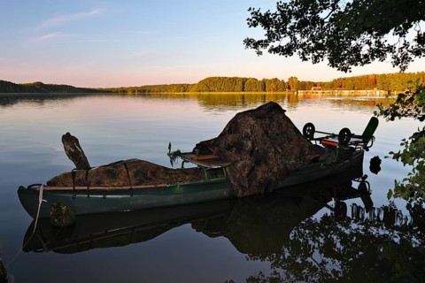 Kayak of a nature photographer in the water, Müritz National Park, Mecklenburg-Western Pomerania,
