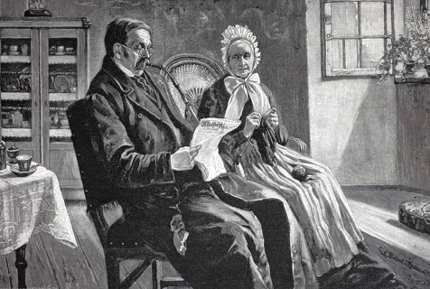 The latest news, man and woman sitting in the living room, he is reading the newspaper, she is