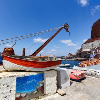 Sign with inscription Ammoudi Bay, fishing harbour, rowing boat, harbour facilities, fish