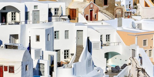 White and colourfully painted holiday homes on a steep slope, stairs, narrow alleys, Oia, Thira,