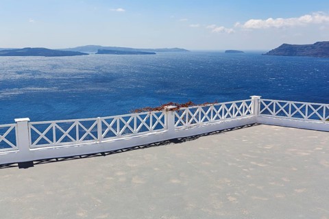 Empty terrace by the sea, view of the caldera, islands on the horizon, Oia, Thira, Santorini,