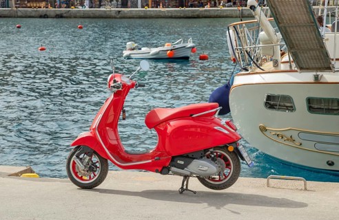 Red vespa scooter parked at Gialos harbour, Gialos, Symi Island, Dodecanese Islands, Greece