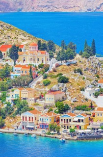 Colourful houses and Evangelismos church at the Harani Bay, Gialos, Symi Island, Dodecanese