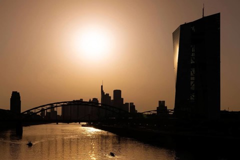 The sun is high above the European Central Bank (ECB) and the Frankfurt banking skyline, Frankfurt
