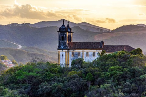 Mountains and baroque church at sunset in the historic city of Ouro Preto in Minas Gerais, Ouro