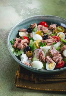Salad with canned tuna, vegetable salad with quail eggs, lettuce, red onion, cherry tomatoes,