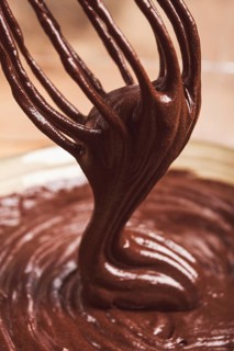 A bowl of chocolate dough, a whisk for whipping, baking, structure and consistency, homemade, top