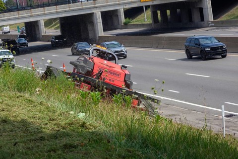 Harper Woods, Michigan - Remote-control mowers are cutting the grass and weeds along Interstate 94