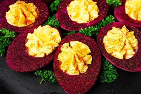 Stuffed eggs, stained with beetroot juice, purple, pitaya powder, top view, top view, close-up, no