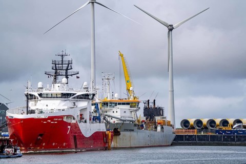 Working vessels in the seaport of Eemshaven, dredger Vitus Bering, aft, cable layer and offshore