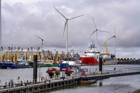 Working vessels in the seaport of Eemshaven, dredger Vitus Bering, aft, cable laying and offshore