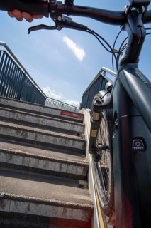 Staircase with bicycle channel, for pushing the bicycle, on the bicycle and pedestrian bridge