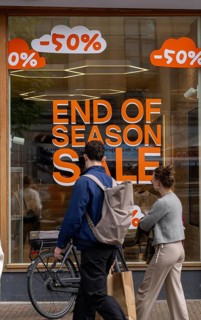 Fashion shop, boutique, with advertisement in the window for the end of season sale, summer sale,