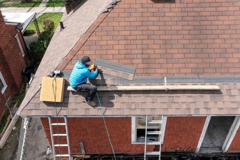 Detroit, Michigan - Workers re-roof a house they are remodeling in the Morningside neighborhood