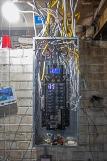 Detroit, Michigan - An electrical panel is wired as workers remodel a house in the Morningside