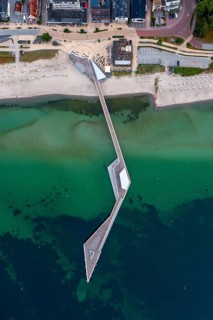Aerial view over Seebrücke, pier and sandy beach at seaside resort Haffkrug along the Baltic Sea,