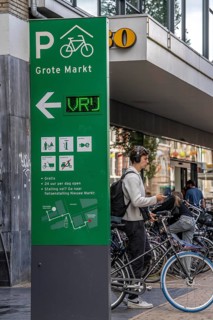 Cycling in the city centre of Groningen, old town, entrance to the bicycle parking garage at the