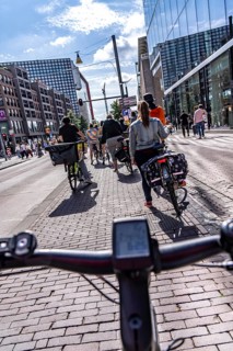 Ride your bike on the central cycle path on Lange Viestraat, Vredenburg, in the city centre of