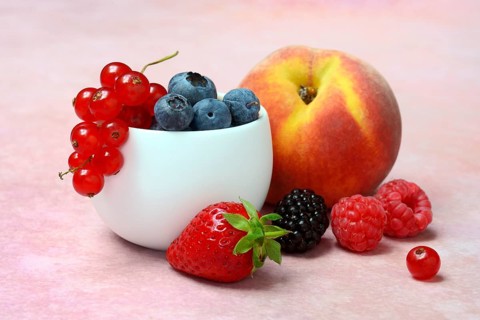 Various fruits in peel, redcurrant, peach, strawberry, blueberry, blackberry, raspberry