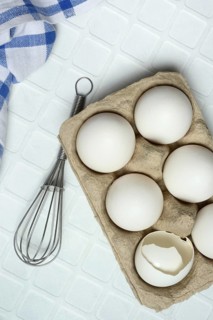 White eggs in packaging with beaters