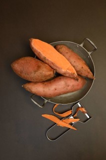 Sweet potatoes in skin with potato peeler, Ipomoea batatas