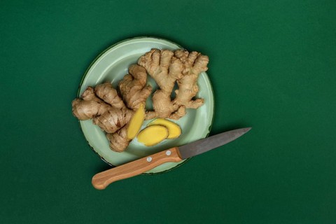 Ginger, ginger tubers with kitchen knife on plate, Zingiber officinale