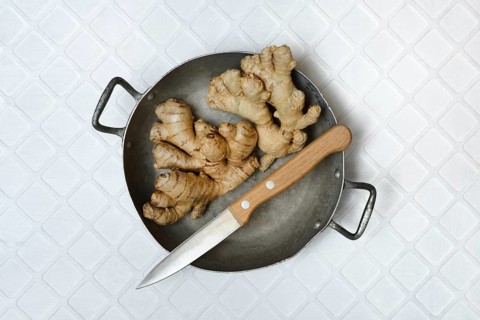Ginger, ginger tubers in bowl with kitchen knife