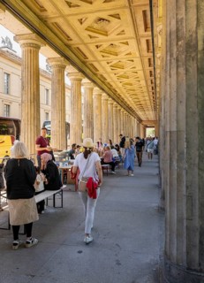 Tourists and passers-by in the colonnade courtyard of the Neues Museum, Bodestraße in Berlin Mitte,