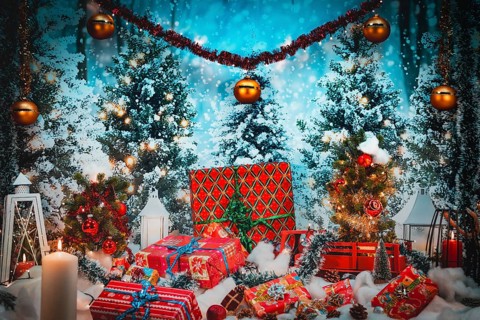 Festive scenery with gifts in front of snow-covered Christmas trees and lights