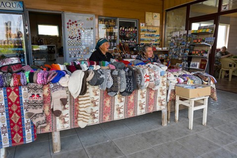 Two woman selling colorful hand-knitted clothes at a market stall, Noratus, Noradus, Gegharkunik