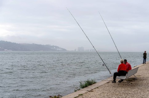 Anglers on Ponte 25 de Abril, 3.2 km long bridge in Portugal with a 2278 meter long suspension