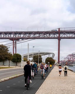 Cyclists on Ponte 25 de Abril, 3.2 km long bridge in Portugal with a 2278 meter long suspension