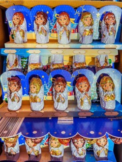 Chocolate Christmas angel in musical instruments printed on colorful staniol paper on a retail